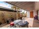 Back patio featuring a covered seating area and tiled table, perfect for enjoying the outdoors at 1725 W Marlette Ave, Phoenix, AZ 85015