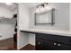 Bathroom vanity featuring dark cabinets, light countertops, and a large mirror at 1725 W Marlette Ave, Phoenix, AZ 85015