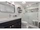 Modern bathroom featuring a glass shower and dark cabinets at 1725 W Marlette Ave, Phoenix, AZ 85015