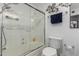 Bathroom featuring a tiled shower with glass doors, a toilet and decorative art hanging on the wall at 1725 W Marlette Ave, Phoenix, AZ 85015