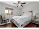 Light bedroom with a cozy chair, white bed, and dark wood floors at 1725 W Marlette Ave, Phoenix, AZ 85015