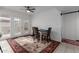 Bright dining area features a ceiling fan, neutral paint, and a vibrant area rug at 1725 W Marlette Ave, Phoenix, AZ 85015