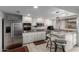 Bright kitchen featuring stainless steel appliances, granite counters, white cabinets, and bar seating at 1725 W Marlette Ave, Phoenix, AZ 85015