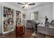 Home office with built-in bookshelves, neutral paint, ceiling fan, and wood flooring at 1725 W Marlette Ave, Phoenix, AZ 85015