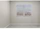 Bedroom featuring a window with blinds and neutral tile flooring at 17735 W Brown St, Waddell, AZ 85355