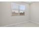 Neutral bedroom featuring gray flooring and a large window with bright light at 17735 W Brown St, Waddell, AZ 85355