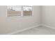 Neutral-walled bedroom with white trim, venetian blinds, and tile flooring at 17735 W Brown St, Waddell, AZ 85355