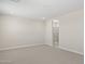 Spacious bedroom with neutral carpet leading to a marble tiled shower and a neutral paint at 17735 W Brown St, Waddell, AZ 85355