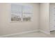 Bedroom showcasing a window and entry doorway at 17735 W Brown St, Waddell, AZ 85355