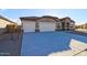 Inviting single-story home features a three-car garage and barrel tile roof at 17735 W Brown St, Waddell, AZ 85355