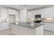 Bright kitchen featuring white cabinets, tiled flooring, and stainless steel appliances at 17735 W Brown St, Waddell, AZ 85355