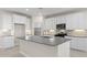 Bright kitchen featuring white cabinets, tiled flooring, and stainless steel appliances at 17735 W Brown St, Waddell, AZ 85355