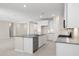 Bright kitchen featuring white cabinets, tiled flooring, and stainless steel appliances at 17735 W Brown St, Waddell, AZ 85355