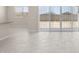 Bright living room featuring tile flooring, venetian blinds and sliding glass door at 17735 W Brown St, Waddell, AZ 85355