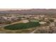 Aerial view of golf course highlighting desert community homes and scenic mountain views at 18016 E Wolf Tree Ln, Rio Verde, AZ 85263