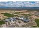 Aerial view of a community with a golf course, mountain views and an aquatic center under a cloudy sky at 18016 E Wolf Tree Ln, Rio Verde, AZ 85263