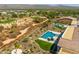 A high-angle shot shows the backyard swimming pool, golf course, and the desert landscape surrounding the house at 18016 E Wolf Tree Ln, Rio Verde, AZ 85263