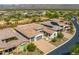 An aerial image depicts the tile roofs of houses, paved driveways, and native landscaping in the surrounding community at 18016 E Wolf Tree Ln, Rio Verde, AZ 85263