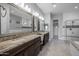 Spacious bathroom featuring granite countertops, dual vanities, a walk-in shower, and a soaking tub at 18016 E Wolf Tree Ln, Rio Verde, AZ 85263