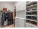 Spacious walk-in closet featuring custom shelves, drawers, and hanging rods for optimal organization at 18016 E Wolf Tree Ln, Rio Verde, AZ 85263