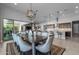 Elegant dining room with stylish lighting and seamless flow to the kitchen and outdoor living space at 18016 E Wolf Tree Ln, Rio Verde, AZ 85263