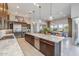 Spacious kitchen features a large center island, stainless steel appliances, and seamless flow to the dining area at 18016 E Wolf Tree Ln, Rio Verde, AZ 85263