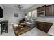 Cozy living room features a gray sofa, ceiling fan, and view from a window at 18016 E Wolf Tree Ln, Rio Verde, AZ 85263