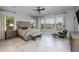 Relaxing main bedroom featuring large windows with views, neutral decor, and a comfortable seating area at 18016 E Wolf Tree Ln, Rio Verde, AZ 85263