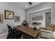 A view of the home office with a large wood desk, decorative art objects, and comfortable seating at 18016 E Wolf Tree Ln, Rio Verde, AZ 85263