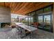 Gorgeous patio with outdoor fireplace, modern dining table, and sleek architectural design at 18016 E Wolf Tree Ln, Rio Verde, AZ 85263