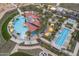 Aerial view of a resort-style pool and recreational area, featuring cabanas, lounge chairs, and lush landscaping at 18016 E Wolf Tree Ln, Rio Verde, AZ 85263