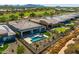 Rear exterior shot of home with pool, putting green, desert landscaping and mountain views in the background at 18016 E Wolf Tree Ln, Rio Verde, AZ 85263