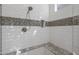 Shower with a built in seat, mosaic tile, and handheld shower head at 18016 E Wolf Tree Ln, Rio Verde, AZ 85263