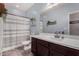 Bathroom featuring a shower/tub combo and a single sink vanity with dark cabinetry at 18146 W Tina Ln, Surprise, AZ 85387