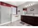 Bathroom featuring a glass enclosed shower and a dual sink vanity with dark cabinetry at 18146 W Tina Ln, Surprise, AZ 85387