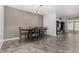 Dining room with seating for six people and tile floors with a modern chandelier at 18146 W Tina Ln, Surprise, AZ 85387