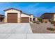 Well-maintained house with a three-car garage and desert landscaping, showcasing the home's curb appeal at 18146 W Tina Ln, Surprise, AZ 85387