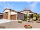 Charming single-story home with a three-car garage, desert landscaping, and a unique colorful pig statue at 18146 W Tina Ln, Surprise, AZ 85387