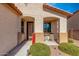 Inviting front porch with stylish decor, a cozy seating area, and desert-friendly landscaping at 18146 W Tina Ln, Surprise, AZ 85387