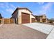 Spacious three-car garage with an extended driveway and low maintenance landscaping perfect for extra parking at 18146 W Tina Ln, Surprise, AZ 85387