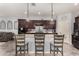 This is an island in the kitchen with granite countertops and modern pendant lighting at 18146 W Tina Ln, Surprise, AZ 85387