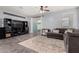 Bright living room featuring tile floors, a ceiling fan, and access to the backyard at 18146 W Tina Ln, Surprise, AZ 85387