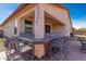 Covered outdoor bar with seating offers a relaxed place to socialize while enjoying the desert sunset at 18146 W Tina Ln, Surprise, AZ 85387