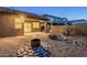 Backyard featuring a covered patio with desert landscaping and fire pit at 1828 W Hemingway Ln, Anthem, AZ 85086