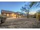 Wide shot of the gravel backyard including the patio, a fire pit, and desert landscaping at 1828 W Hemingway Ln, Anthem, AZ 85086