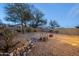 Expansive backyard with a low-maintenance landscape featuring a rock stream, a fire pit, and privacy walls at 1828 W Hemingway Ln, Anthem, AZ 85086