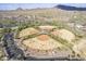 Aerial view of community baseball fields and surrounding desert landscape and neighborhood at 1828 W Hemingway Ln, Anthem, AZ 85086