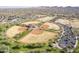 Aerial view of community ballfields with green spaces, parking, and neighborhood in the background at 1828 W Hemingway Ln, Anthem, AZ 85086