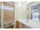 Bathroom with a vanity, large mirror, and a view to the toilet and shower/tub at 1828 W Hemingway Ln, Anthem, AZ 85086