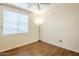 Bright bedroom with vinyl wood-look flooring, ceiling fan, and a large window at 1828 W Hemingway Ln, Anthem, AZ 85086